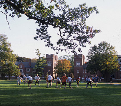 Photo of a group of people playing a game on a campus yard